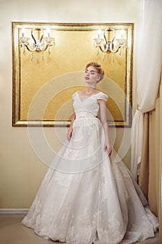 Full length portrait of beauty bride in white dress. Classic sty
