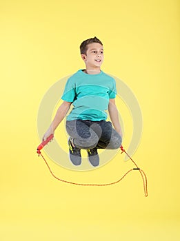 Full length portrait of boy jumping rope