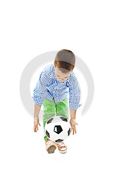 Full length portrait of a boy with a soccer ball