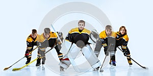 Full-length portrait of boys, children, professional hockey players  over white background