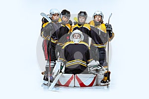 Full-length portrait of boys, children, professional hockeys player  over white background. Friendship