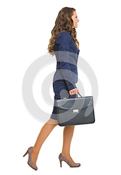 Full length portrait of business woman going sideways