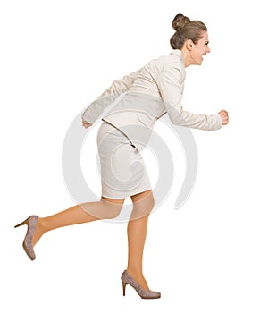 Full length portrait of business woman running sideways