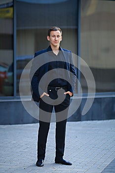 Full length portrait of businessman in formals standing.