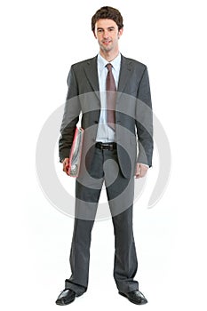 Full length portrait of businessman holding folder