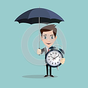 Full length portrait of a businessman standing under umbrella and keeps an alarm clock