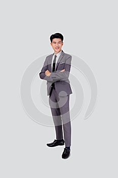 Full length portrait businessman in suit with crossed his arms standing isolated on white background.