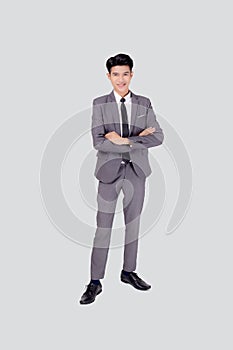 Full length portrait businessman in suit with crossed his arms standing isolated on white background.