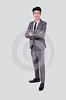 Full length portrait businessman in suit with crossed his arms standing isolated on white background.