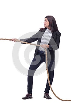 Full length portrait of businesswoman pulling an rope in tug of war concept