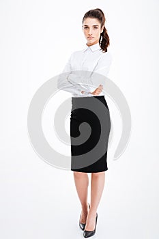 Full length portrait of a businesswoman standing with arms folded