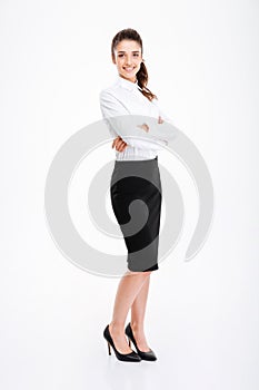 Full length portrait of a businesswoman standing with arms folded