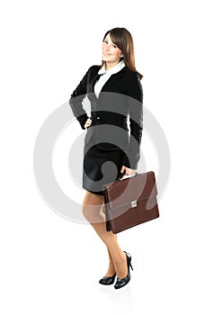 Full length portrait of a businesswoman walking with a briefcase