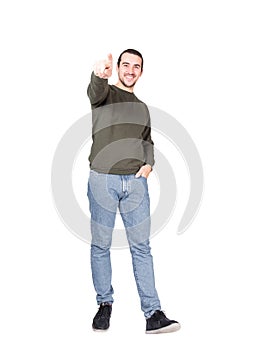 Full length portrait of carefree and friendly young man pointing forefinger to camera, smiling broadly one hand in pocket, stylish