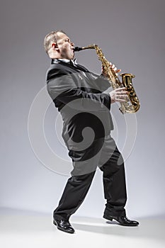 Full Length Portrait of Caucasian Mature Concentrated Saxophone Player