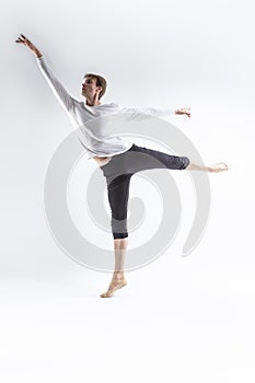 Full Length Portrait of Caucasian Young, Handsome Sporty Athletic Ballet Dancer with Lifted Hand Over White