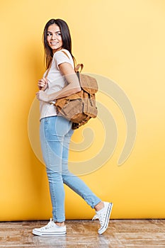 Full length portrait of a charming woman with backpack