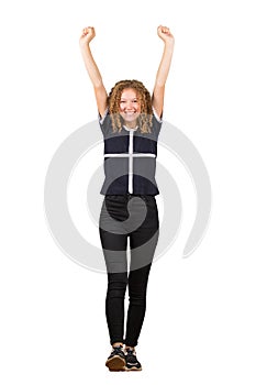 Full length portrait of a cheerful adolescent girl, curly hair, raising hands up as making a step forward. Celebrate success like
