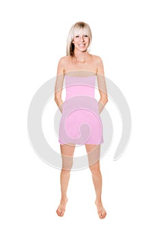 Full length portrait of a cheerful blonde woman wearing a short pink summer dress