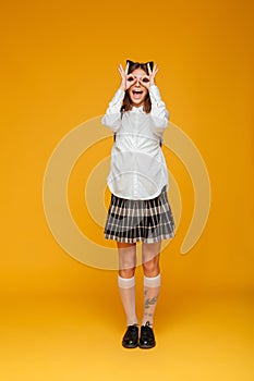 Full length portrait of a cheerful schoolgirl