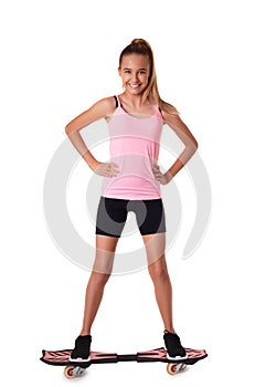 Full length portrait of cheerful sporty teen girl standing on wave board, isolated on white background