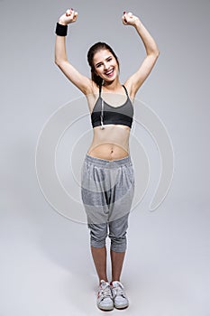 Full length portrait of a cheerful sporty woman