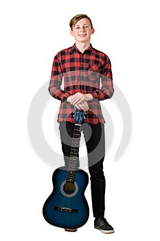 Full length portrait of cheerful teenage guy posing with his favourite blue acoustic guitar isolated on white background. Music