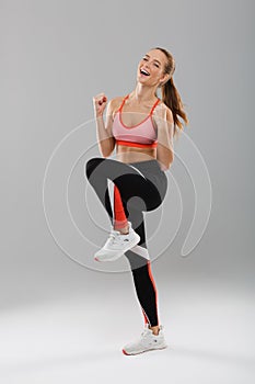 Full length portrait of a cheerful young sportsgirl celebrating