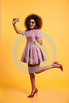 Full length portrait of a cheery afro american woman