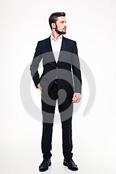 Full length portrait of a confident businessman looking away