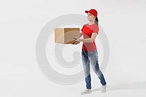 Full length portrait of delivery woman in red cap, t-shirt giving order boxes isolated on white background. Female