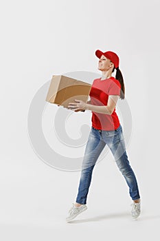 Full length portrait of delivery woman in red cap, t-shirt giving order boxes isolated on white background. Female