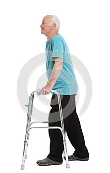 Full length portrait of elderly man using walking frame