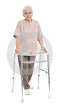 Full length portrait of elderly woman using walking frame