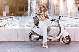 Full-length portrait of elegant brunette girl in glasses and summer hat posing after bike ride. Slim tall young woman