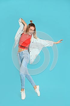 Full length portrait of emotional woman dancing