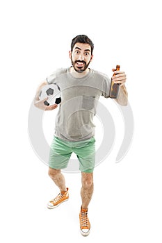 Full length portrait of an euphoric sport fan holding a beer bottle and football cheering