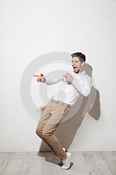 Full length portrait of an excited young man