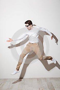 Full length portrait of an excited young man