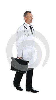 Full length portrait of experienced doctor in uniform on white background