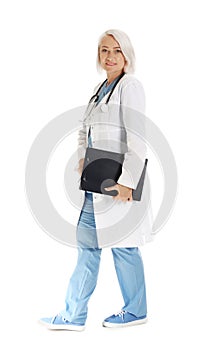 Full length portrait of female doctor with clipboard. Medical staff