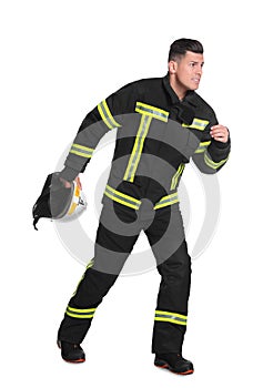 Full length portrait of firefighter with helmet on white background