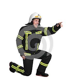 Full length portrait of firefighter in uniform and helmet on white