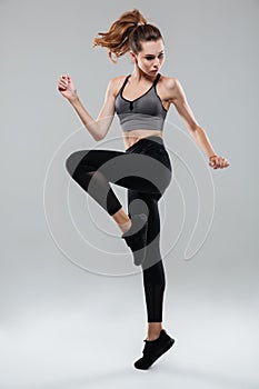 Full length portrait of a fitness woman in sportswear posing