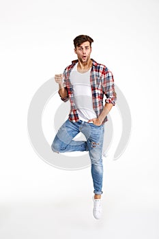 Full length portrait of a funny casual man jumping