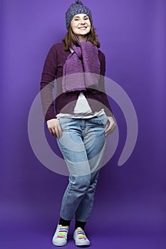 Full Length Portrait of Funny Caucasian Adult Female In Warm Knitted Hat and Casual Clothing Posing With Hands in Jeans Pockets