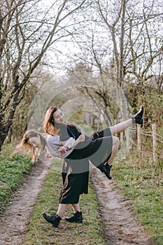 Full length portrait, the girl holds another girl on her back, Having fun together, positive emotions, bright colors. two