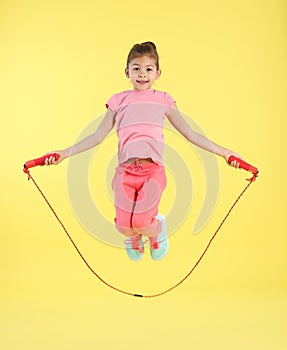 Full length portrait of girl jumping rope