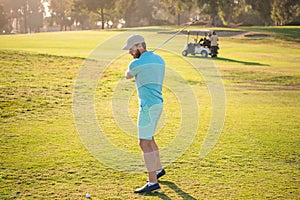 full length portrait of golfer in cap with golf club. people lifestyle. man playing game