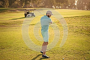 full length portrait of golfer in cap with golf club. people lifestyle. man playing game